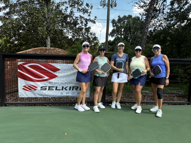 A group of women players after a pickleball clinic on the private court