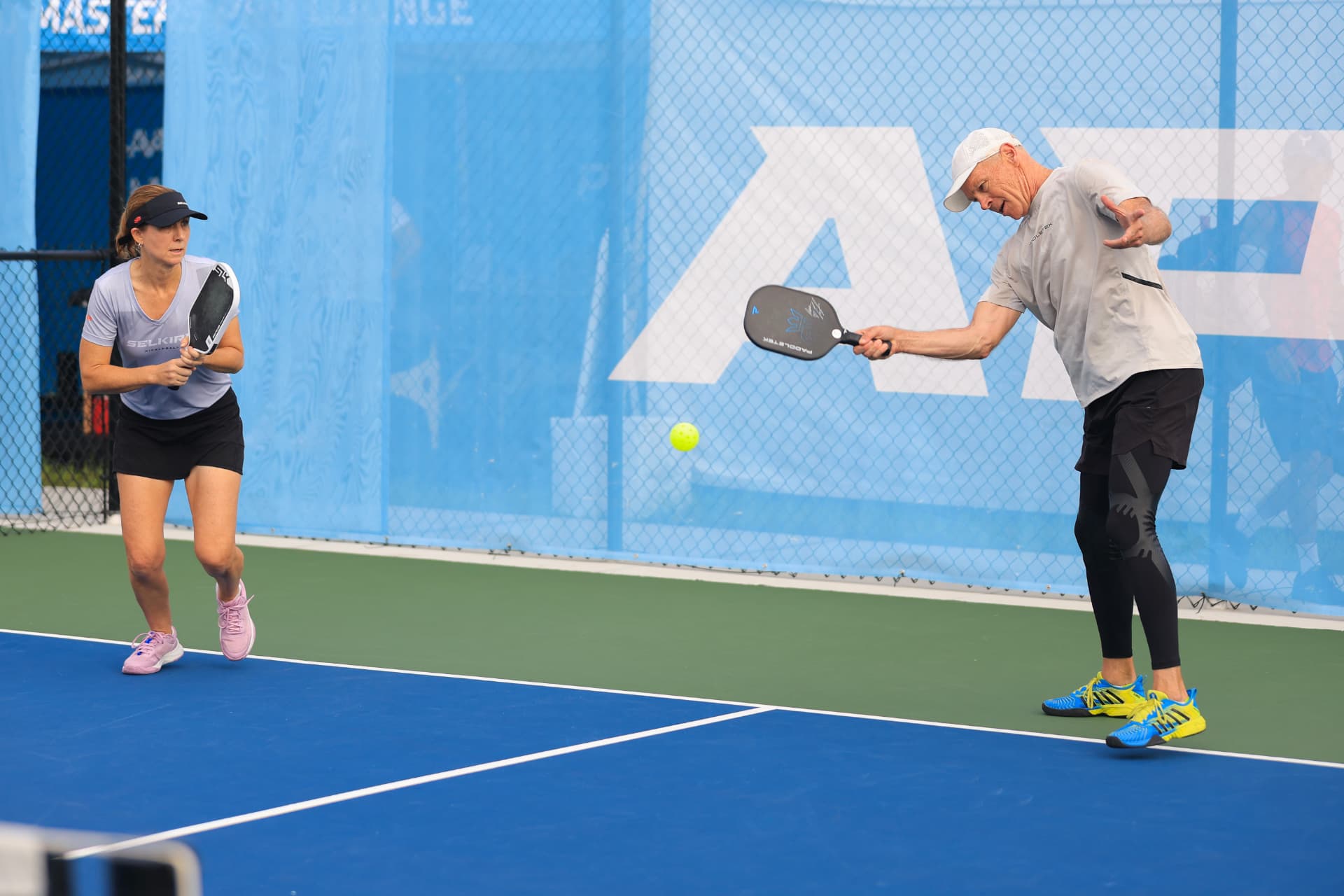 Heather Lovett playing mixed doubles at a tournament